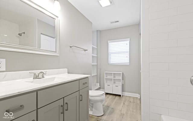 2940 N Park Ave, Indianapolis, IN 46205 - bathroom featuring wood finished floors, toilet, and vanity