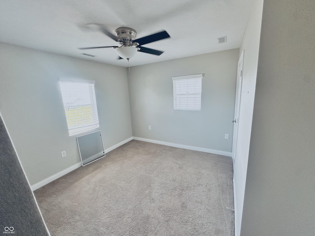 2940 N Park Ave, Indianapolis, IN 46205 - carpeted empty room with plenty of natural light, ceiling fan, and baseboards