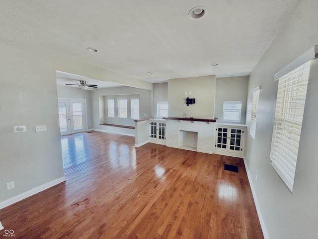 2940 N Park Ave, Indianapolis, IN 46205 - unfurnished living room featuring light wood finished floors, baseboards, ceiling fan, a brick fireplace, and recessed lighting