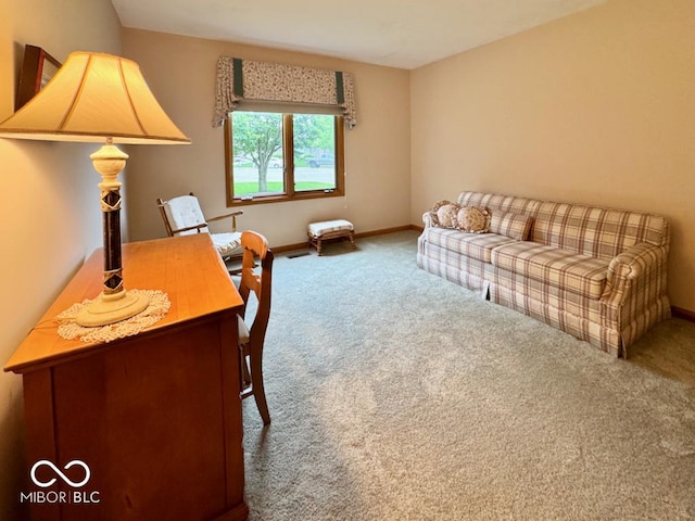 carpeted living area with baseboards