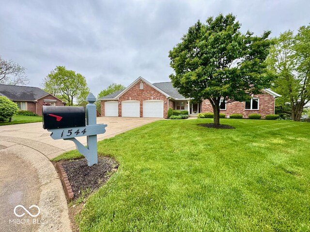 view of front of home with a front yard, concrete driveway, a garage, and brick siding