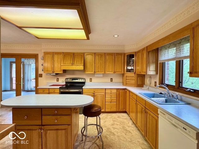 kitchen featuring white dishwasher, stainless steel electric stove, a sink, light countertops, and a kitchen breakfast bar