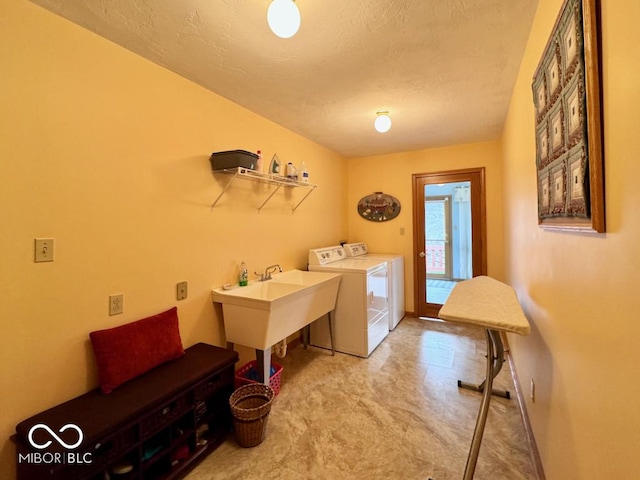 laundry area with separate washer and dryer, light carpet, and a textured ceiling