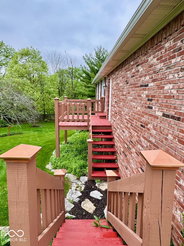 wooden terrace with stairs and a yard