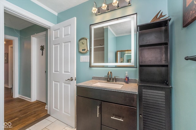 bathroom with wood finished floors and vanity