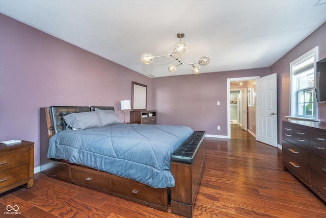 bedroom featuring baseboards, dark wood-style floors, and a chandelier
