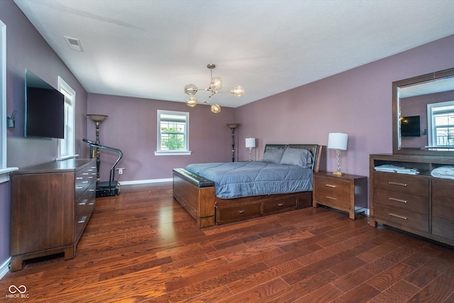 bedroom featuring a chandelier, baseboards, visible vents, and dark wood-type flooring