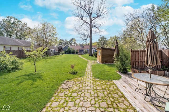view of yard with fence and an outbuilding
