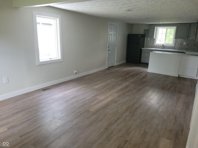 2855 Walker Ave, Indianapolis, IN 46203 - interior space with baseboards, a sink, a textured ceiling, and wood finished floors