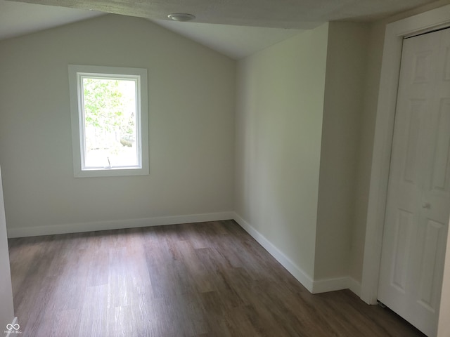 2855 Walker Ave, Indianapolis, IN 46203 - additional living space with baseboards, dark wood-style floors, and lofted ceiling