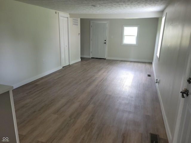 2855 Walker Ave, Indianapolis, IN 46203 - spare room featuring a textured ceiling, baseboards, visible vents, and wood finished floors