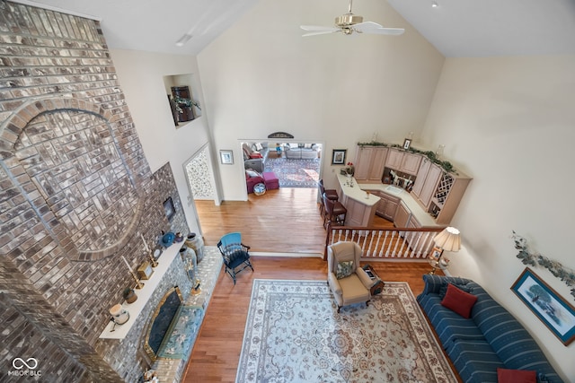6821 Ripple Creek Dr, Lafayette, IN 47905 - living area with a ceiling fan, a brick fireplace, wood finished floors, and high vaulted ceiling