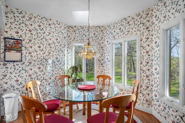 6821 Ripple Creek Dr, Lafayette, IN 47905 - dining area featuring baseboards, wallpapered walls, wood finished floors, and a chandelier