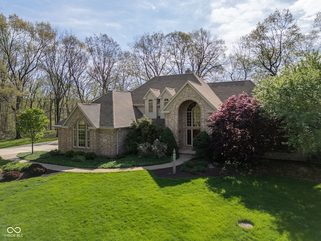 6821 Ripple Creek Dr, Lafayette, IN 47905 - view of front facade featuring a chimney, a front lawn, and stone siding