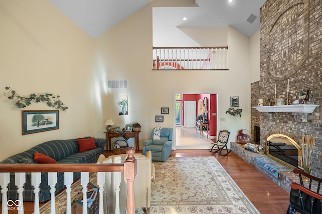 6821 Ripple Creek Dr, Lafayette, IN 47905 - living room featuring a brick fireplace, high vaulted ceiling, visible vents, and wood finished floors