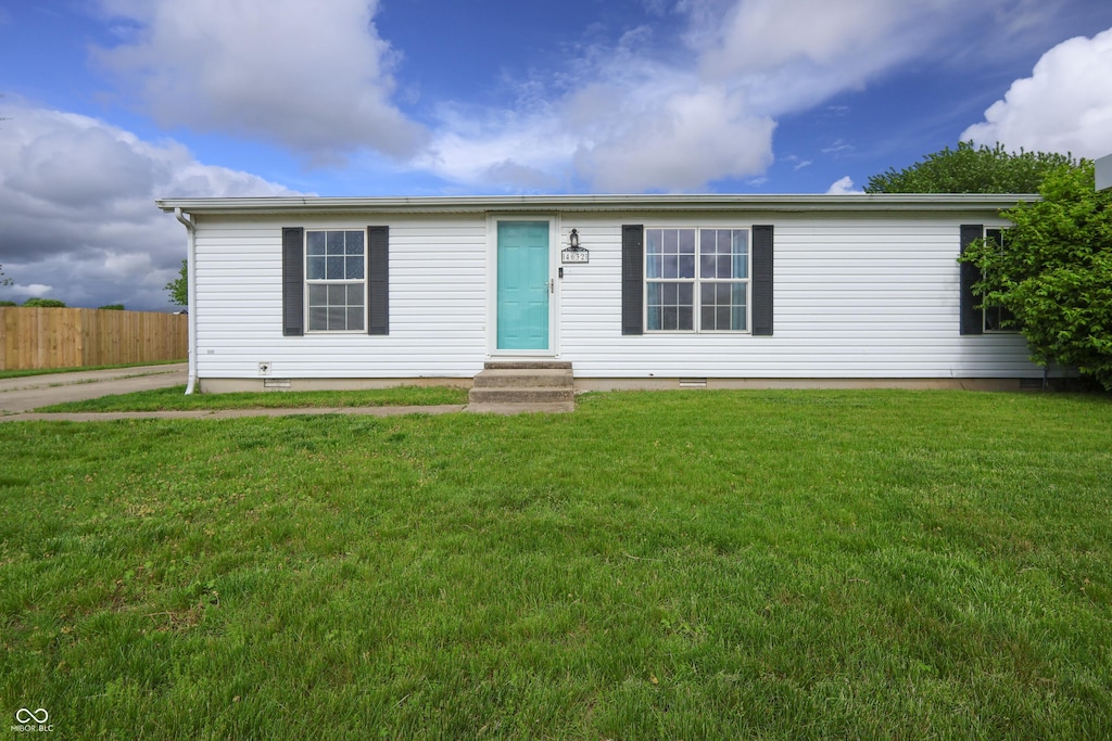 manufactured / mobile home featuring entry steps, a front yard, fence, and crawl space