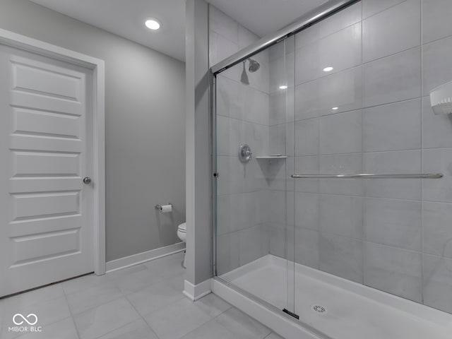 bathroom featuring a shower stall, tile patterned flooring, toilet, baseboards, and recessed lighting