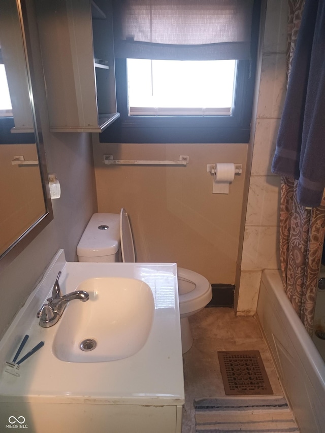 bathroom featuring vanity, toilet, shower / tub combo, and visible vents