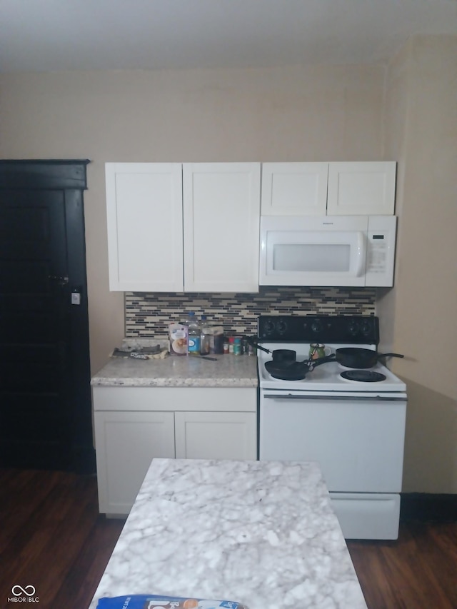 kitchen featuring white cabinetry, white appliances, and dark wood finished floors