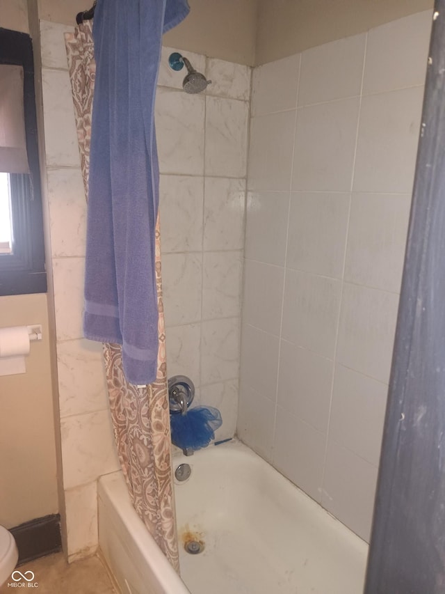 bathroom with toilet and shower / bathtub combination with curtain