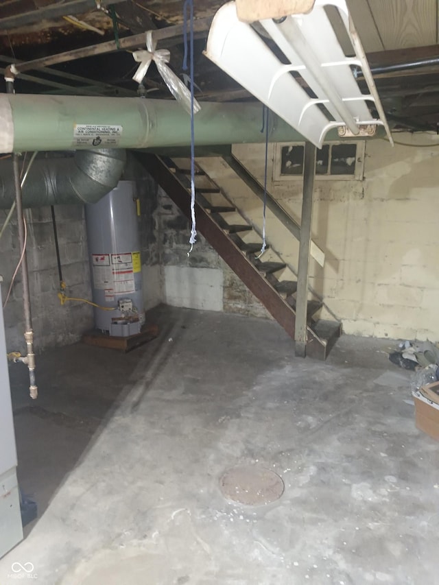 unfinished below grade area with stairway and gas water heater