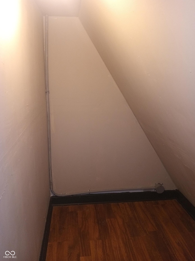 additional living space featuring lofted ceiling and wood finished floors