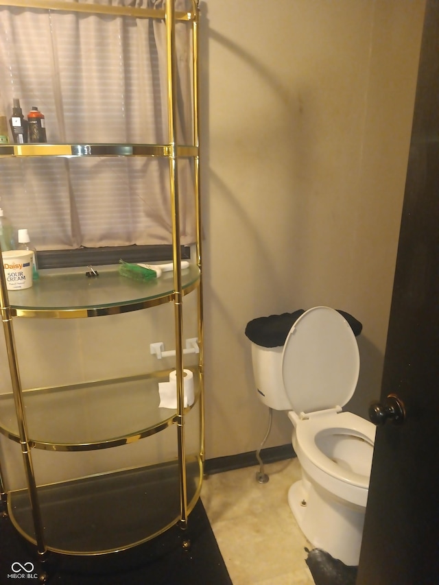 bathroom featuring toilet and baseboards