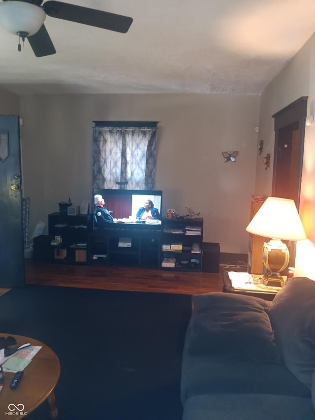 living area featuring wood finished floors and a ceiling fan