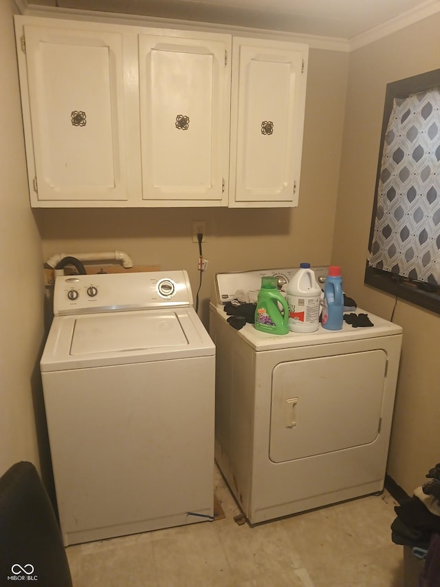 laundry area with cabinet space, washing machine and dryer, electric panel, and ornamental molding