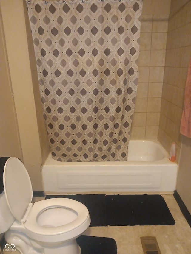 bathroom with toilet and shower / bathtub combination with curtain