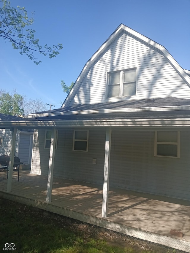 view of home's exterior with a gambrel roof