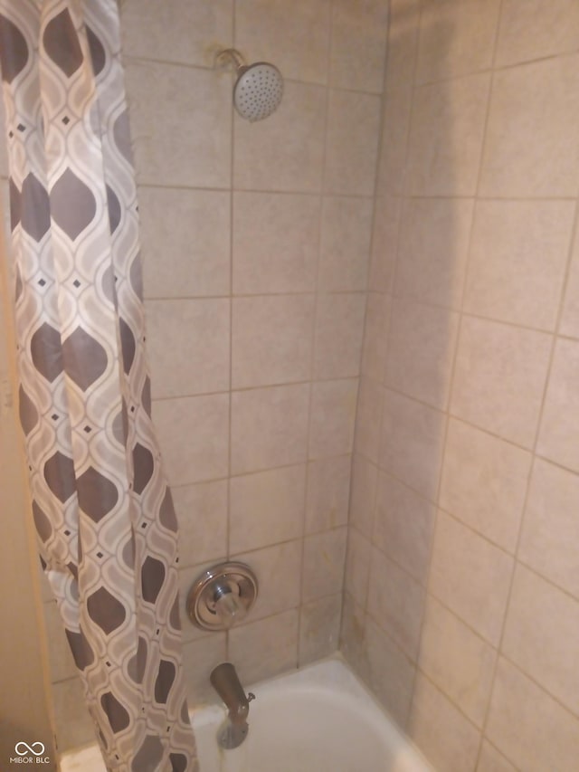 bathroom with shower / bathtub combination with curtain