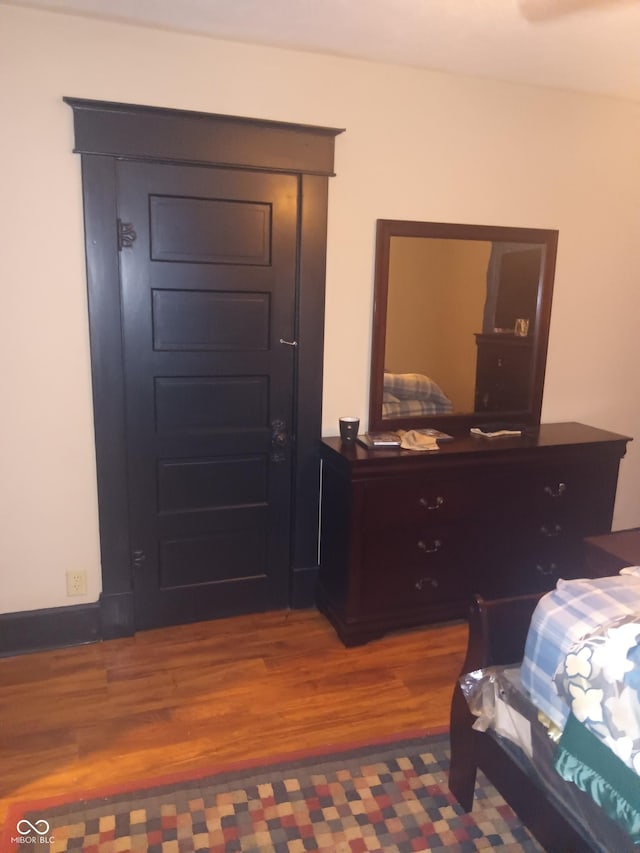 bedroom with wood finished floors