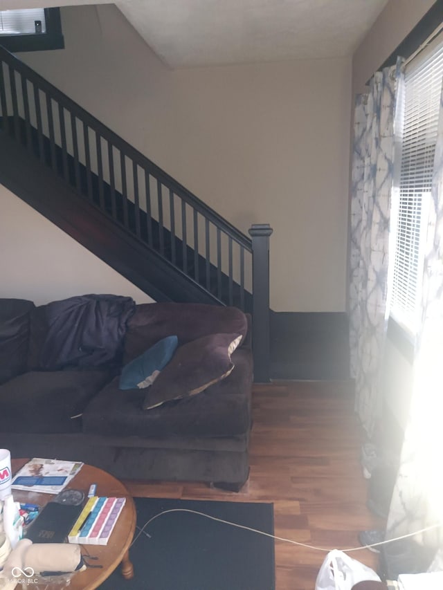 living area with stairway and wood finished floors