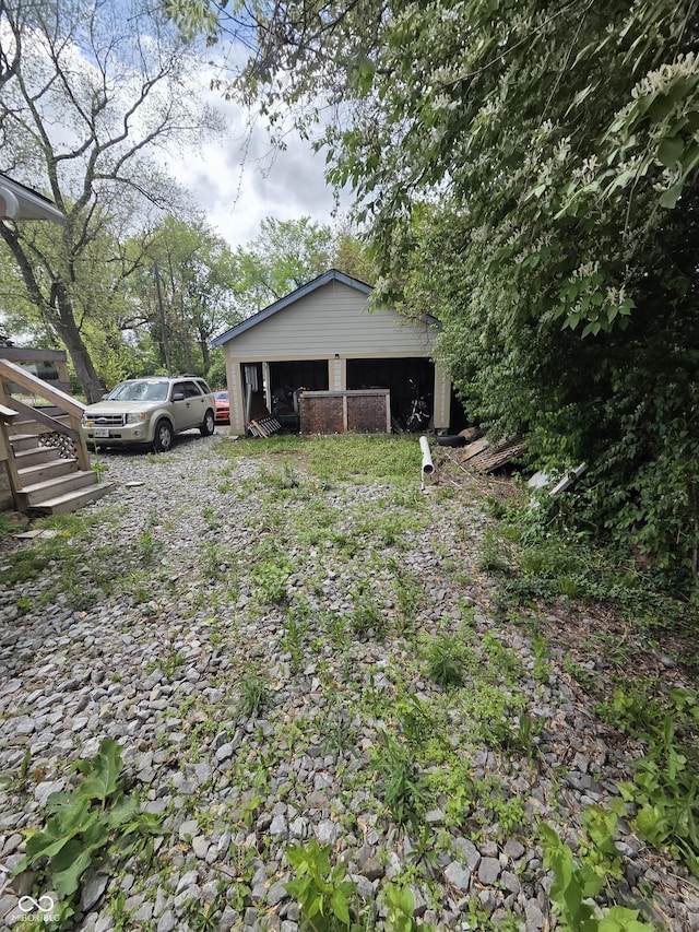 view of yard with stairway and a garage