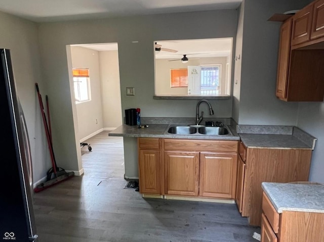 3031 E 38th St, Indianapolis, IN 46218 - kitchen with freestanding refrigerator, wood finished floors, a ceiling fan, light countertops, and brown cabinetry