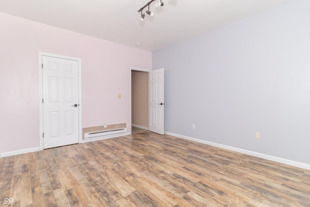 2761 Winding Creek Ln, Greenfield, IN 46140 - spare room featuring wood finished floors and baseboard heating