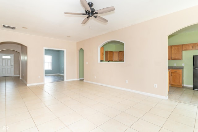 2761 Winding Creek Ln, Greenfield, IN 46140 - unfurnished room featuring a ceiling fan, arched walkways, and light tile patterned flooring