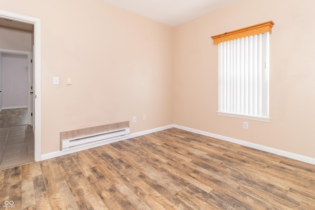 2761 Winding Creek Ln, Greenfield, IN 46140 - spare room featuring a baseboard heating unit and wood finished floors