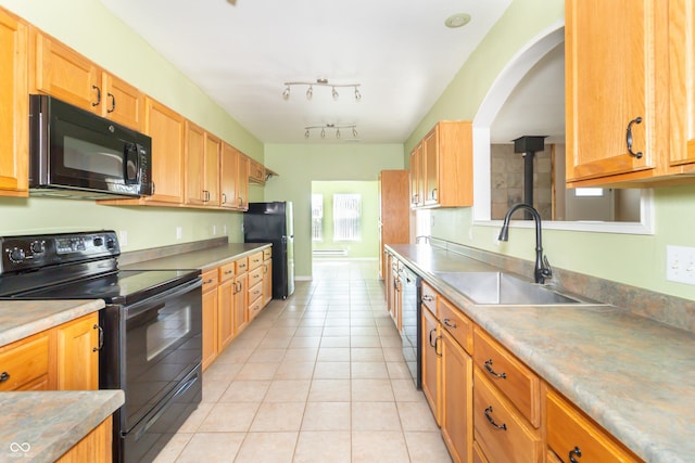 2761 Winding Creek Ln, Greenfield, IN 46140 - kitchen with black appliances, light tile patterned flooring, and light countertops