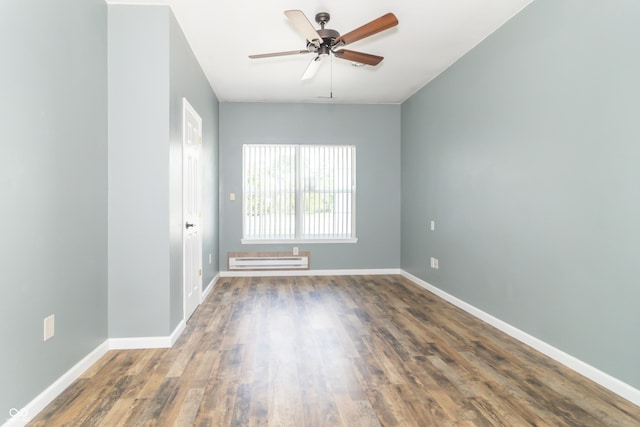 2761 Winding Creek Ln, Greenfield, IN 46140 - empty room featuring a baseboard radiator, a ceiling fan, and wood finished floors