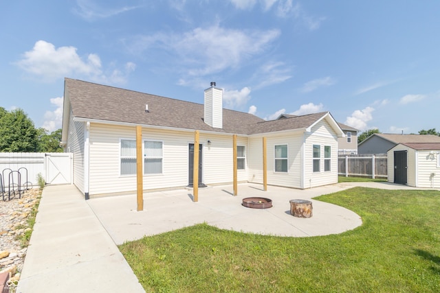 2761 Winding Creek Ln, Greenfield, IN 46140 - back of house with a shed, a fire pit, a patio, a fenced backyard, and a chimney