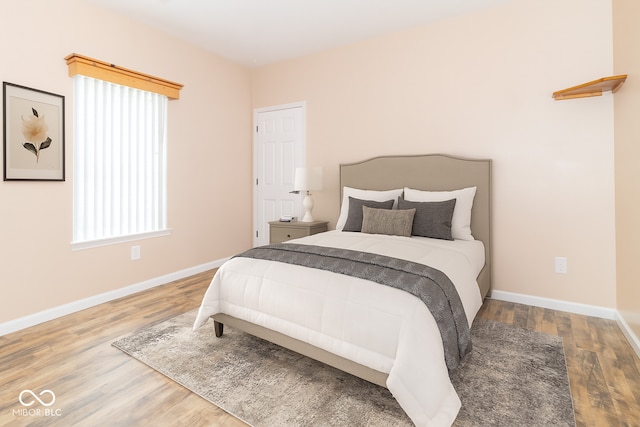 2761 Winding Creek Ln, Greenfield, IN 46140 - bedroom featuring wood finished floors and multiple windows