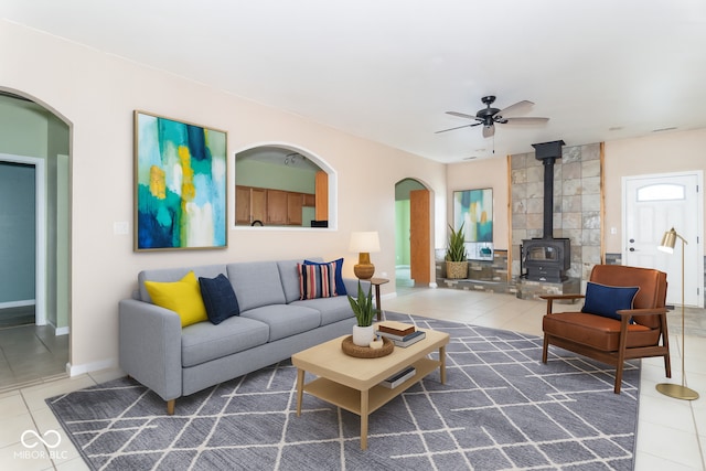 2761 Winding Creek Ln, Greenfield, IN 46140 - tiled living room with a wood stove, ceiling fan, and arched walkways