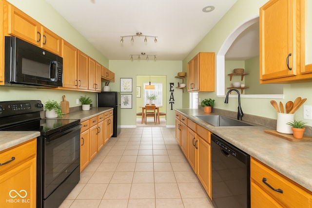 2761 Winding Creek Ln, Greenfield, IN 46140 - kitchen with black appliances, light tile patterned floors, and rail lighting