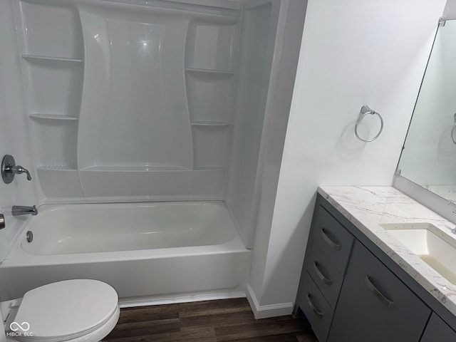 full bathroom with shower / bathtub combination, toilet, wood finished floors, vanity, and baseboards