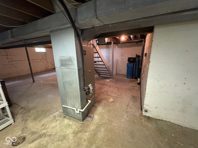 unfinished below grade area with heating unit and stairway