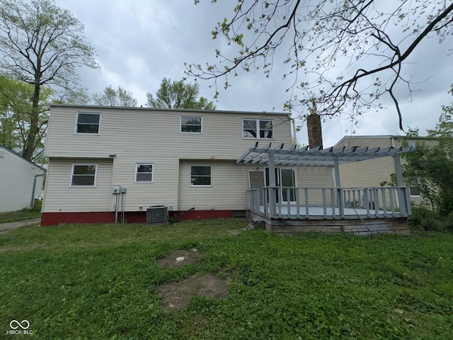 rear view of property featuring a lawn, a chimney, a pergola, central AC unit, and a deck