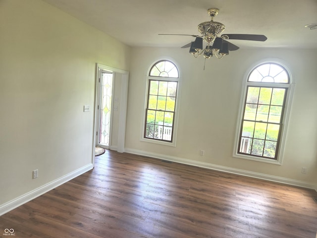 9909 E Mcgregor Rd, Indianapolis, IN 46259 - spare room featuring dark wood-style floors, a ceiling fan, and baseboards