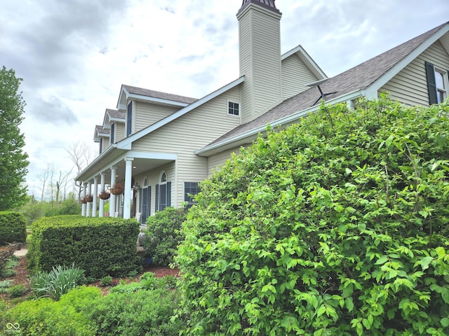 9909 E Mcgregor Rd, Indianapolis, IN 46259 - view of side of property with a chimney and a shingled roof